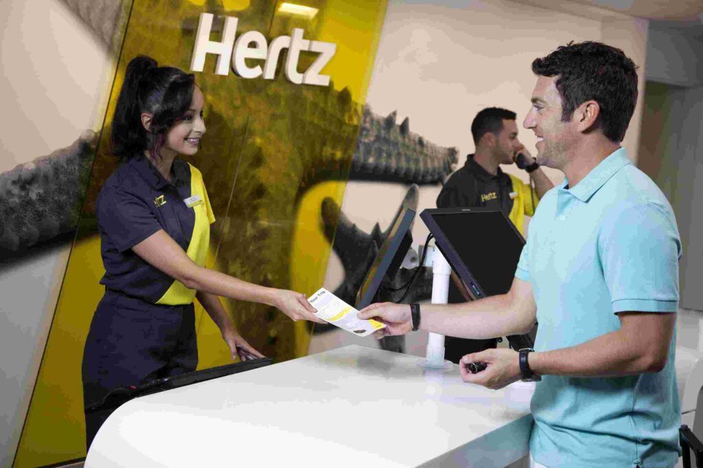 Hertz car rental empoyee giving reciept to customer
